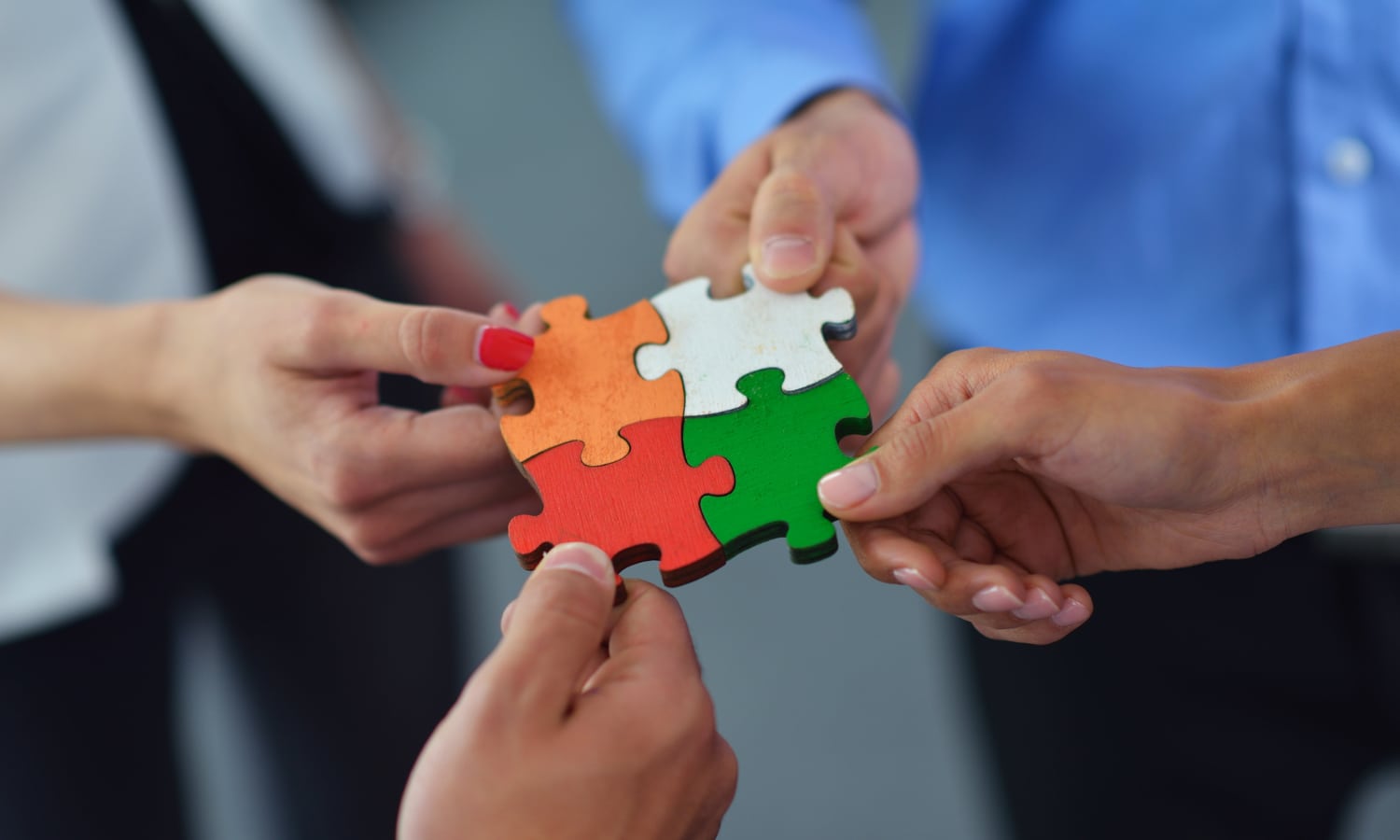 Group of business people assembling jigsaw puzzle ISO Management System Standards